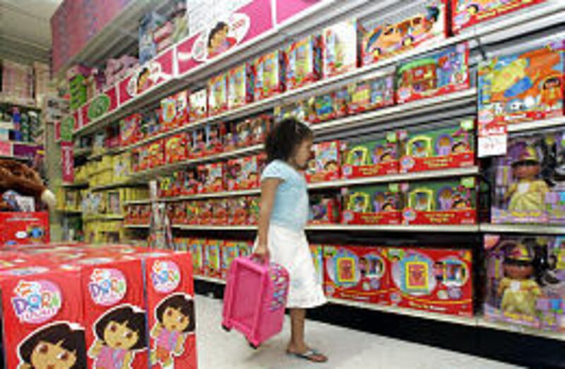 Lizbeth Sanchez, 6, walks past a Dora the Explorer display at a Toys "R" Us store in Doral, Fla.