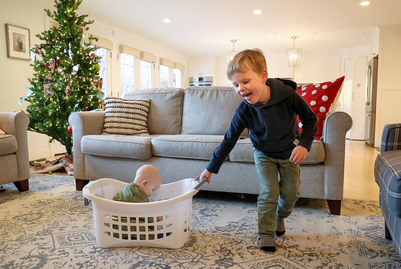 Matthew Lowe, who was hospitalized with RSV, plays with his brother Scotty at home in Salt Lake City.