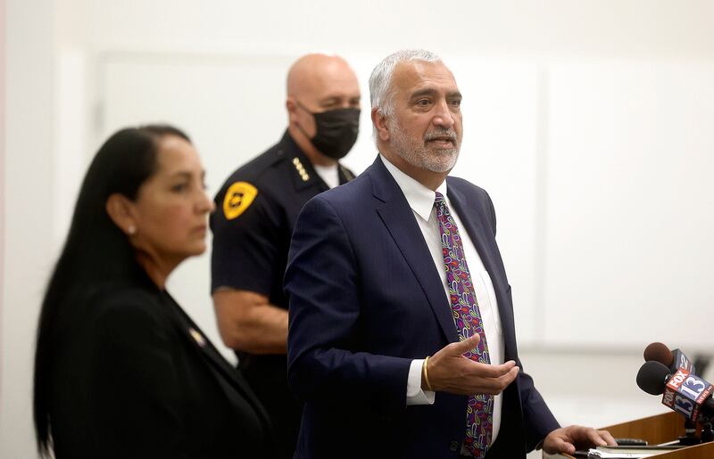 Salt Lake County Sheriff Rosie Rivera, left, and Salt Lake City Police Chief Mike Brown, center, listen as Salt Lake County District Attorney Sim Gill speaks at a press conference at the Salt Lake County District Attorney's Office building in Salt Lake City on Wednesday about a joint effort to reduce gun-related violence by no longer accepting plea bargains for gun-related crimes.