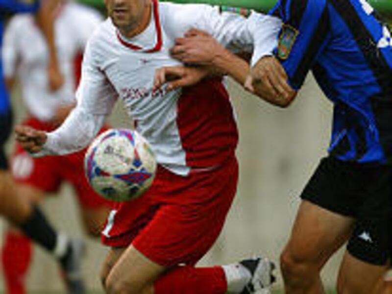 Blitzz forward Fadi Afash tries to fend off the Reserves' Alex Salazar Friday evening.