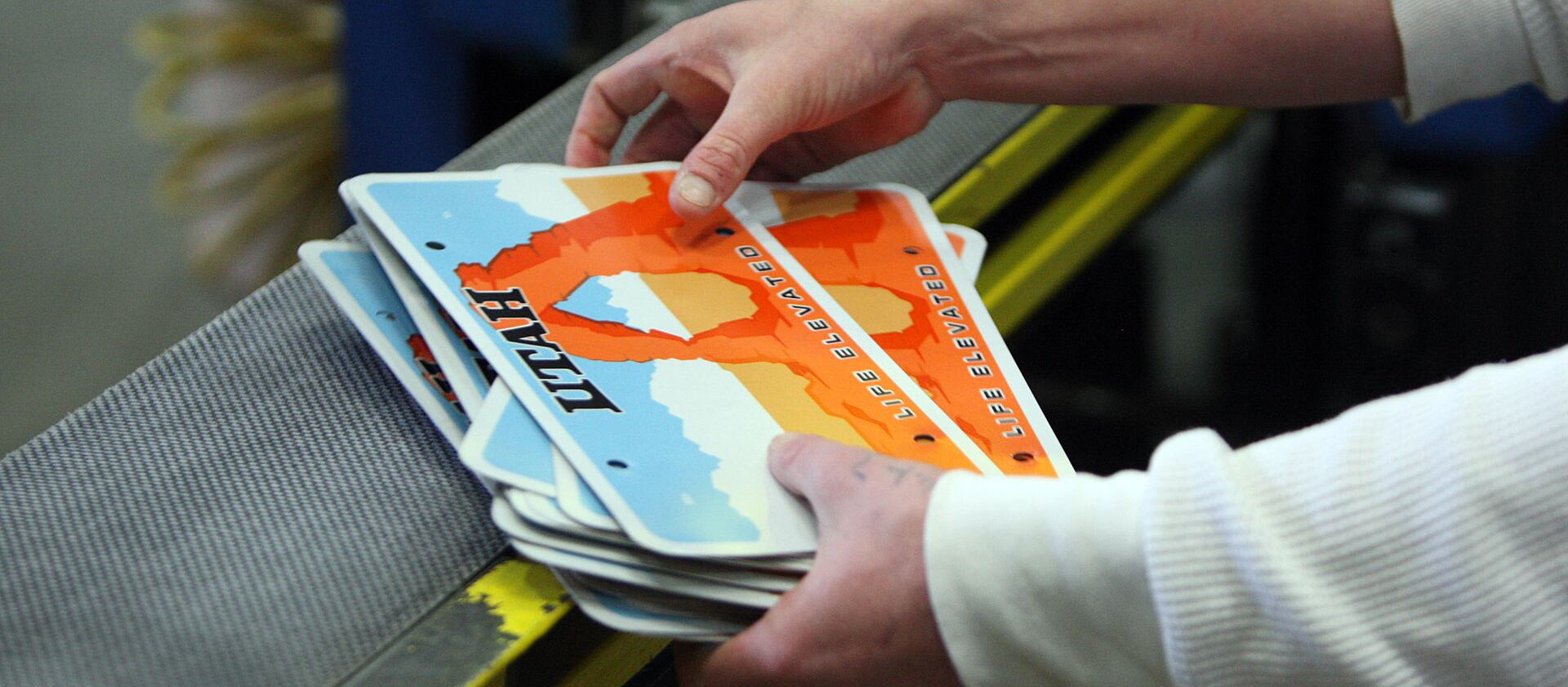 An inmate does quality control on license plates at the Utah State Prison in Draper on Wednesday, March 5, 2014.