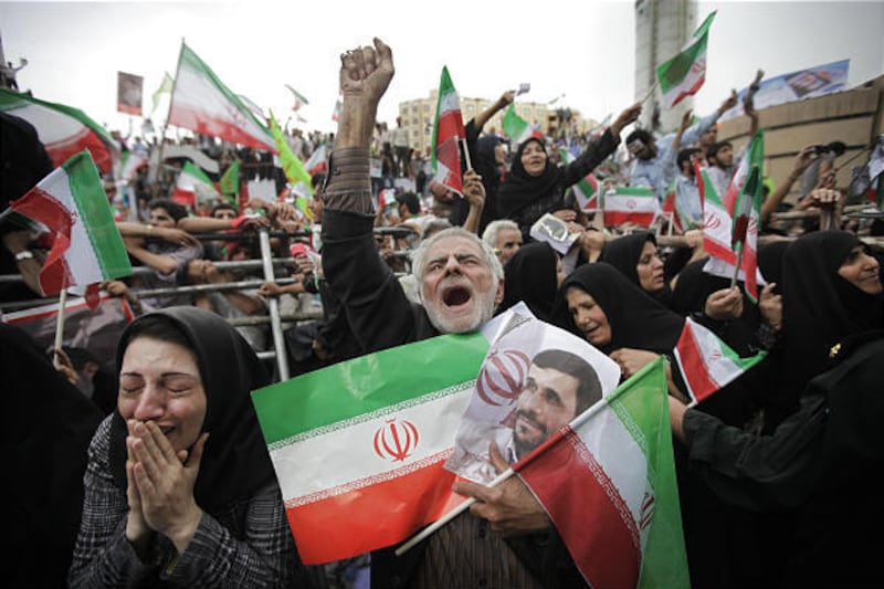 Supporters of Iranian President Mahmoud Ahmadinejad cheer him at a rally in Tehran's Vali Asr square.