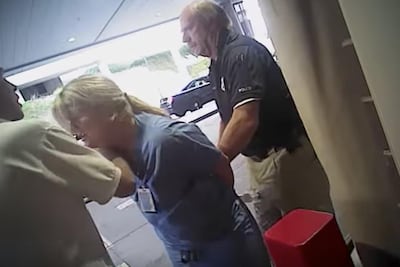 Salt Lake police detective Jeff Payne, right, is seen making a controversial arrest of University of Utah Hospital charge nurse Alex Wubbels in Salt Lake City on July 26, 2017.