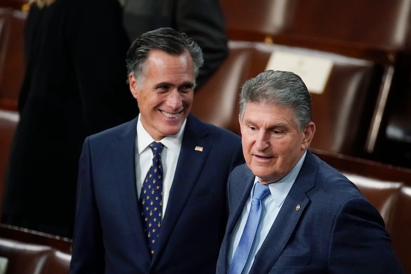 Sen. Joe Manchin, D-W.Va., right, and Sen. Mitt Romney, R-Utah, arrive to hear President Joe Biden’s State of the Union address at the Capitol on March 1, 2022.