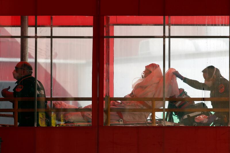 Emergency medical technicians wheel a patient into Elmhurst Hospital Center’s emergency room, Tuesday, April 7, 2020, in the Queens borough in New York, during the current coronavirus outbreak. (AP Photo/Kathy Willens)