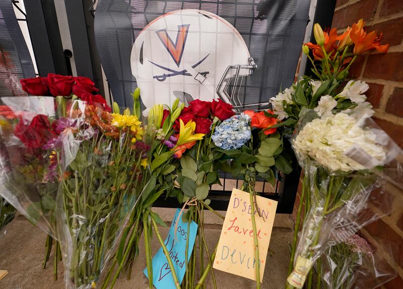 Memorial flowers and notes sit near Scott Stadium after three football players were killed on the campus of the University of Virginia Tuesday Nov. 15, 2022.