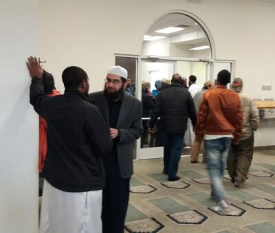 Imam Muhammed Mehtar, right center, speaks with a friend at the Khadeeja Islamic Center in West Valley City last week.