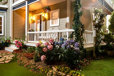 A bunch of hydrangea flowers adorn the porch of a dollhouse built by Larry Elkins matching the dream home he and his late wife Linda had planned to build, as seen on Wednesday, March 27, 2019.