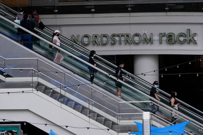 People wear face masks as they shop at the Nordstrom in downtown Los Angeles.