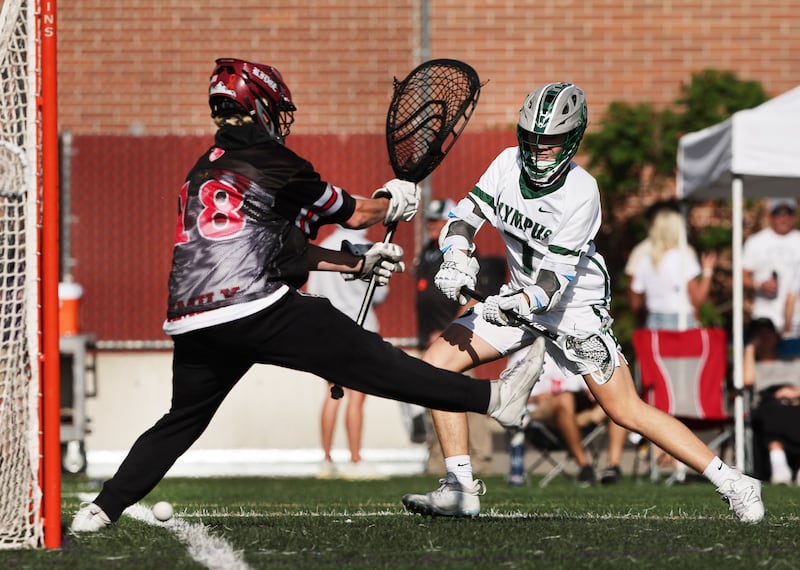Olympus’ Cole Cummings, shoots and scores on Northridge’s goalie Callum Dibble, as they play in semifinal lacrosse action at Westminster in Salt Lake City on Wednesday, May 24, 2023.