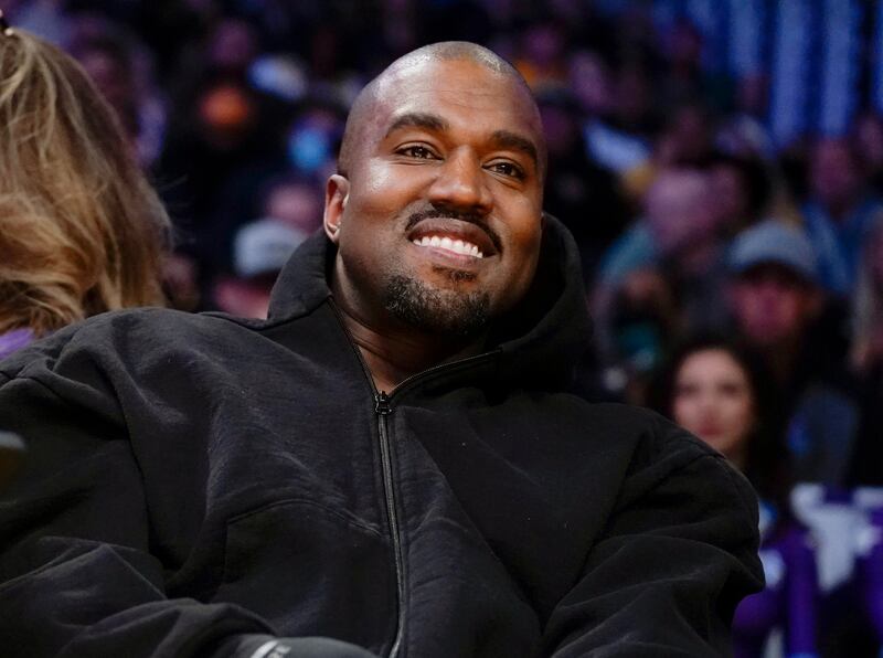 Kanye West watches an NBA basketball game between the Washington Wizards and the Los Angeles Lakers.