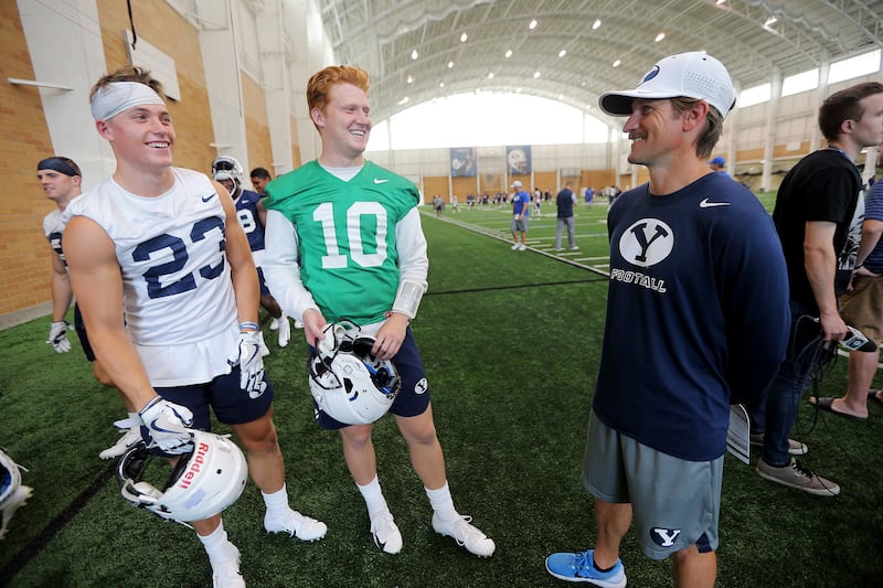 In this Aug. 10, 2018 file photo, Zayne Anderson and Joe Critchlow talk with BYU’s passing game coordinator and quarterbacks coach Aaron Roderick after a walkthrough in their indoor practice facility in Provo. Roderick will succeed Jeff Grimes as BYU’s offensive coordinator.