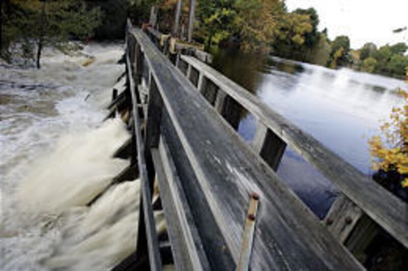 Whittenton Pond Dam continued to hold Tuesday against pressure of rain-swollen Mill River. An evacuation order remains in effect.