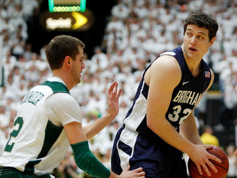 Colorado State guard Wes Eikmeier defends as BYU guard Jimmer Fredette, wearing blue, looks to pass