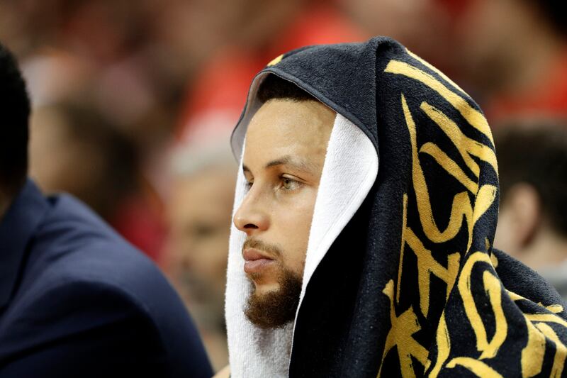 Golden State Warriors' Stephen Curry watches play from the bench during the first half of Game 6 of a second-round NBA basketball playoff series against the Houston Rockets on Friday, May 10, 2019, in Houston.