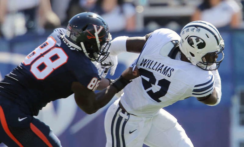Brigham Young running back Jamaal Williams (21) is tackled by Virginia linebacker Max Valles (88) as BYU and Virginia play Saturday, Sept. 20, 2014, at LaVell Edwards Stadium in Provo.