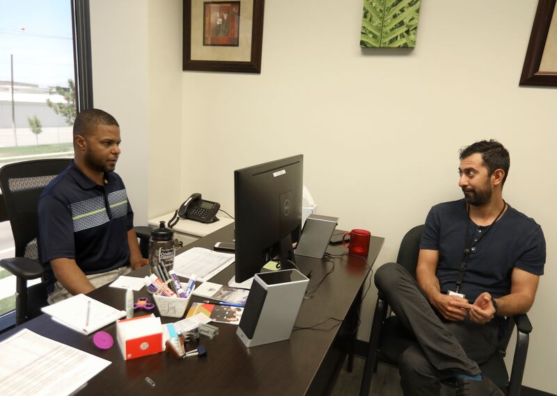 Ali F. Abid, job developer at Catholic Community Services, and Wisam Khudhair, mental health program coordinator, at Catholic Community Services, work at Catholic Community Services in Salt Lake City on Thursday, July 25, 2019. Bothe Abid and Kudhair are