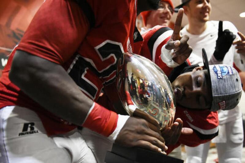 Western Kentucky wide receiver Nicholas Norris kisses the Conference USA championship trophy as they celebrate in the locker room after defeating Louisiana Tech 58-44 in an NCAA college football game, Saturday, Dec. 3, 2016 at L.T. Smith Stadium in Bowlin