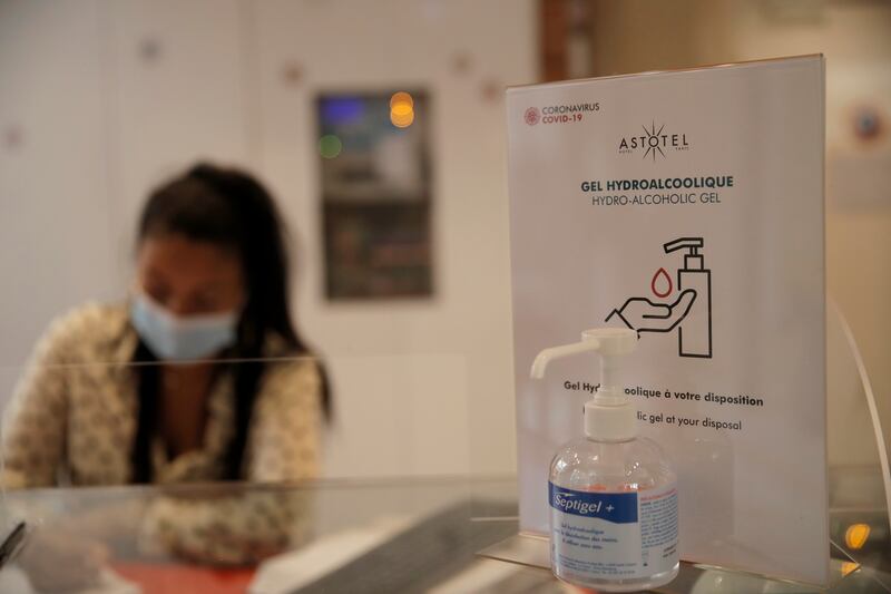 A hand sanitizer bottle is pictured at the reception desk at the 34B hotel, in Paris, Monday, June 15, 2020.