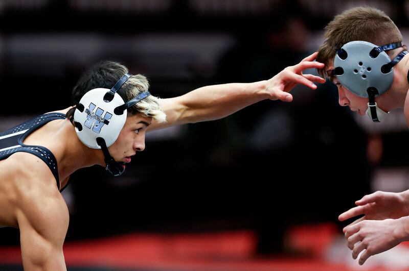 Westlake’s Israel Borge, left, wrestles Fremont’s Colby Tennant
