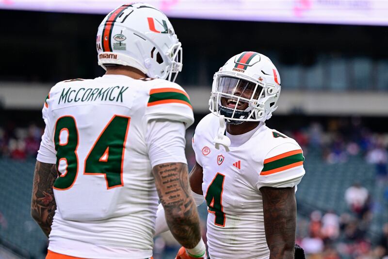 Miami wide receiver Colbie Young (4) celebrates his touchdown with Cam McCormick during a game against Temple on Sept. 23, 2023.