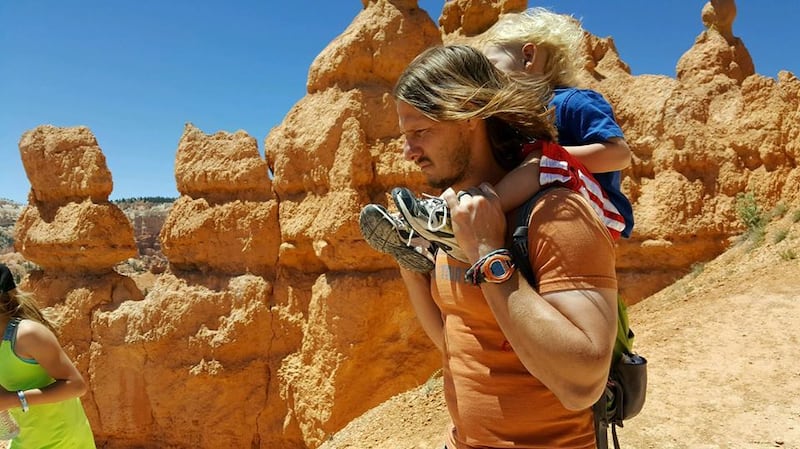 Arianne Brown's husband, Adam Brown, carries their 4-year-old son, Axel, on a hike in Bryce Canyon.