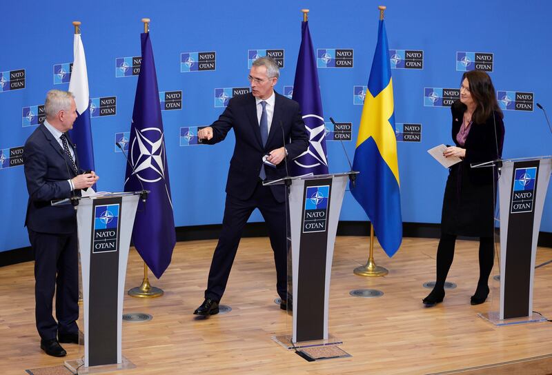NATO Secretary-General Jens Stoltenberg, center, greets Finland’s Foreign Minister Pekka Haavisto, left, and Sweden’s Foreign Minister Ann Linde, right, at the end of a media conference at NATO headquarters.