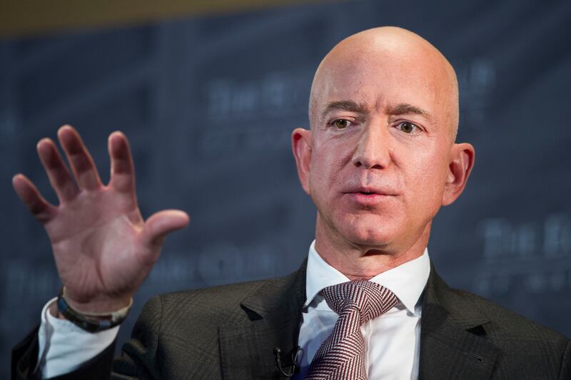 FILE- In this Sept. 13, 2018, file photo Jeff Bezos, Amazon founder and CEO, speaks at The Economic Club of Washington's Milestone Celebration in Washington. Bezos says the National Enquirer is threatening to publish nude photographs of him unless his pri