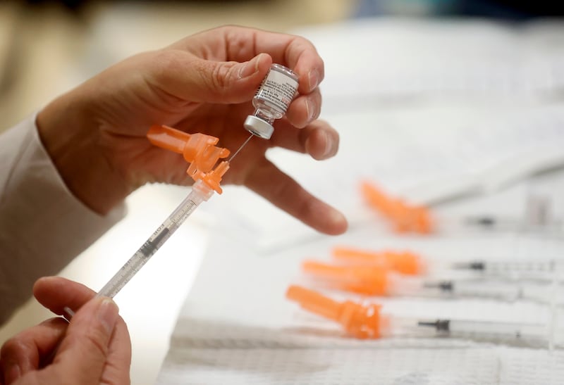 A Salt Lake County Health Department employee prepares Pfizer COVID-19 booster shots at a free vaccine clinic in Taylorsville in 2022.
