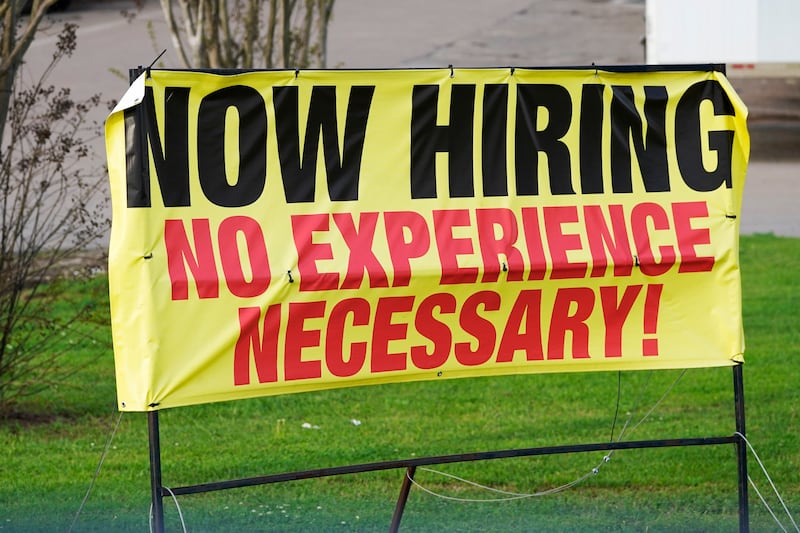 A roadside banner beckons potential employees outside a company in Hattiesburg, Miss., on March 27, 2021.