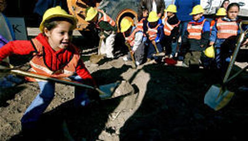 Joselin Acosta, 4, and other preschoolers from the Head Start class at Monroe Elementary School take a shovelful of dirt Wednesday at the groundbreaking for a Head Start facility in West Valley City.