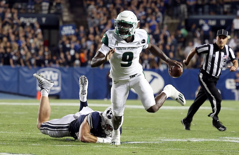 South Florida quarterback Timmy McClain escapes the tackle of BYU defensive lineman Fisher Jackson in Provo.