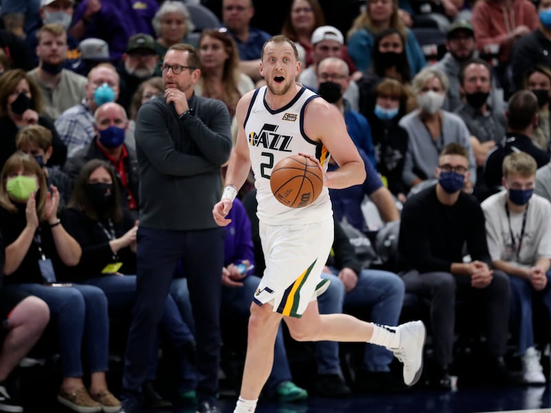 Utah Jazz guard Joe Ingles, wearing white, dribbles the ball.