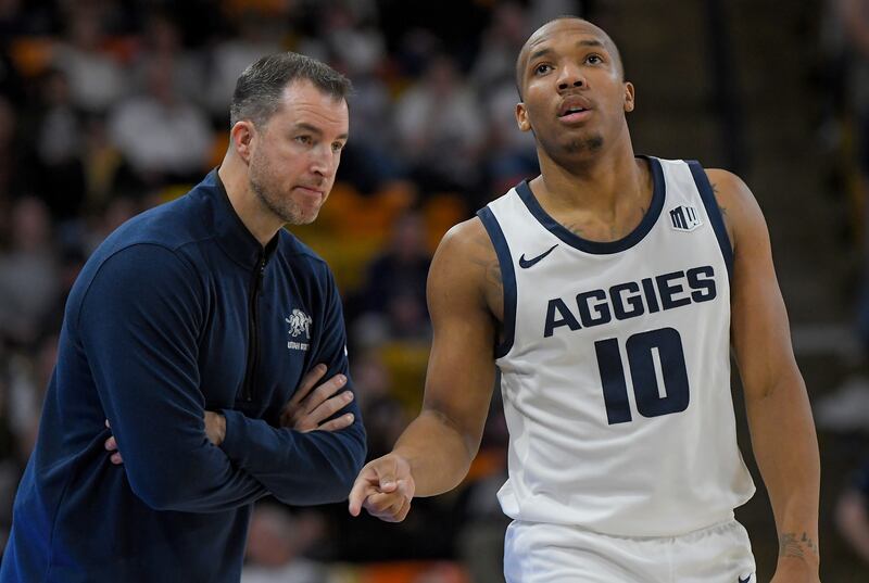 Utah State coach Danny Sprinkle talks with guard Darius Brown II during a game against Wyoming, Jan. 9, 2024, in Logan.