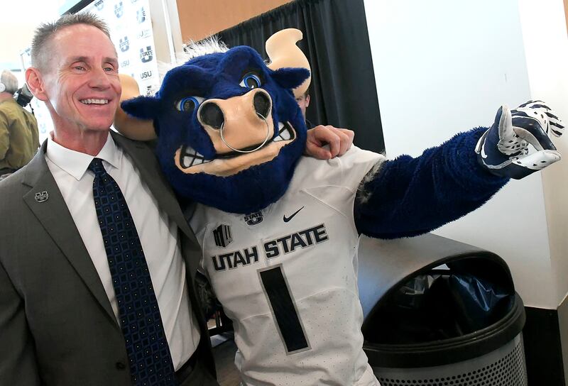 Gary Andersen poses for a photo with Big Blue after speaking at a press conference where he was introduced as the new head football coach at Utah State, Tuesday, Dec. 11, 2018, in Logan, Utah. (Eli Lucero/The Herald Journal via AP)