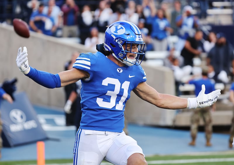 BYU linebacker Max Tooley celebrates his touchdown after an interception against Utah State in Provo, Sept. 29, 2022.