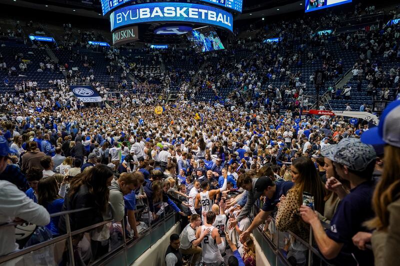 BYU players go back on the court to celebrate with fans after BYU toppled No. 2-ranked Gonzaga 91-78 at the Marriott Center.