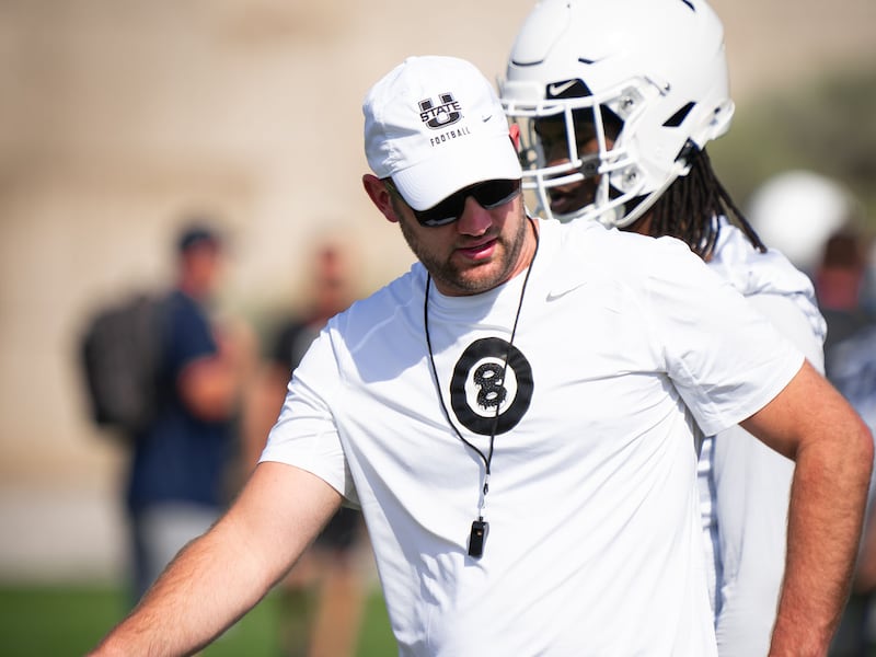 Utah State interim head coach Nate Dreiling coaches his team during fall camp in Logan.
