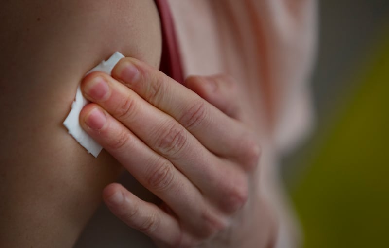A woman presses a pad onto her upper arm after receiving a dose of Moderna’s COVID-19 vaccine at a COVID-19 vaccination and testing site in Brussels, Tuesday. Feb. 9, 2021.