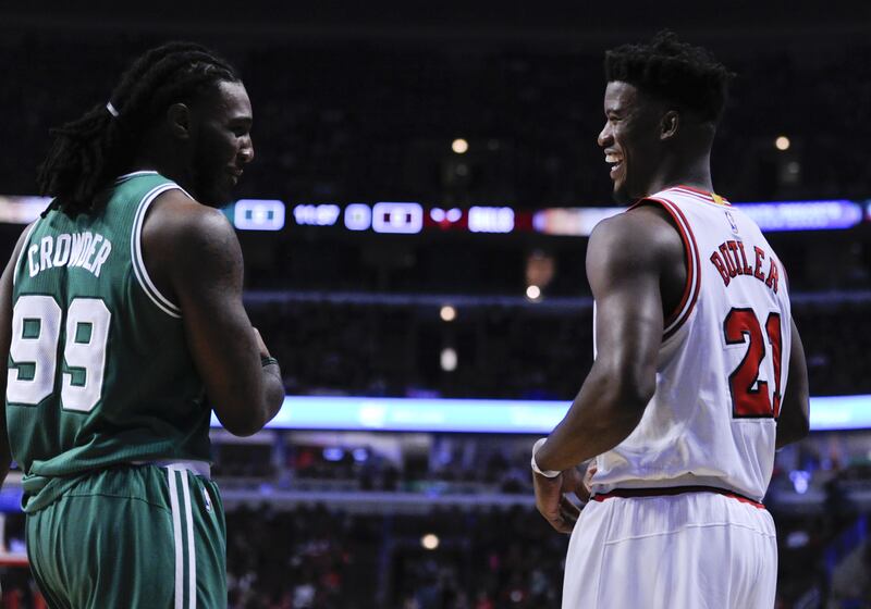 Chicago Bulls' Jimmy Butler, right, talks with Boston Celtics' Jae Crowder (99) before a season opening NBA basketball game against the Boston Celtics Thursday, Oct. 27, 2016, in Chicago. (AP Photo/Matt Marton)
