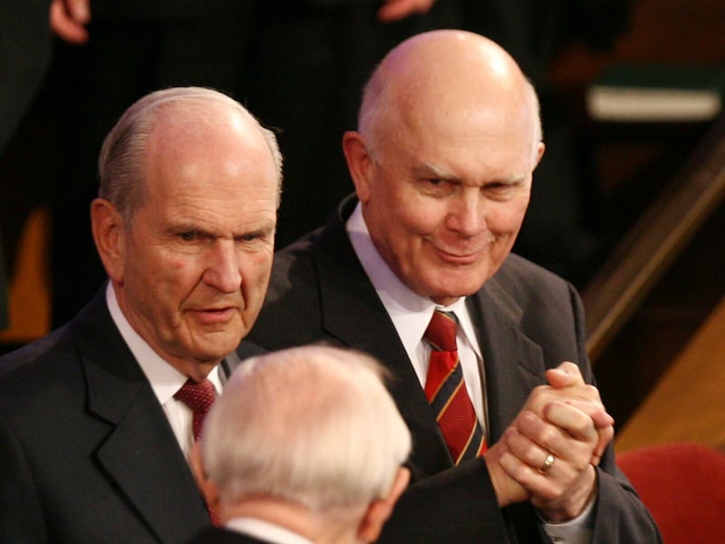 Elder Dallin H. Oaks, right, gestures to President Gordon B. Hinckley as President Hinckley passes him and Elder Russell M. Nelson while leaving the Salt Lake Tabernacle on Temple Square following the afternoon session of The Church of Jesus Christ of Latter-day Saints' 177th Annual General Conference March 31, 2007.