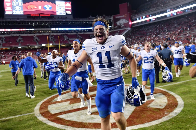 BYU linebacker Harrison Taggart (11) and teammates celebrate a win over Arkansas after a game on Sept. 16, 2023
