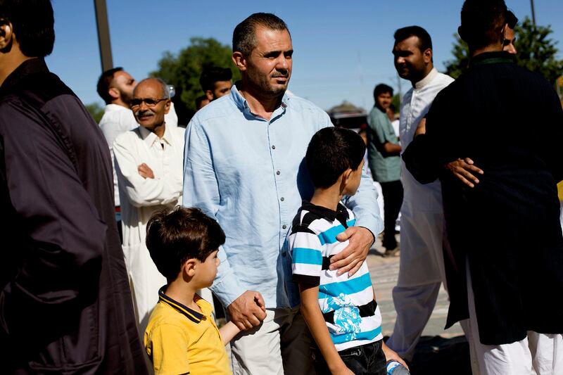 Malek Hamad holds onto his sons, Eslam and Abdullah, while searching for his cousin after praying on Eid al-Fitr at the Khadeeja Islamic Center in West Valley City on Sunday, June 25, 2017. The Hamads had only lived in Salt Lake City for a month and were