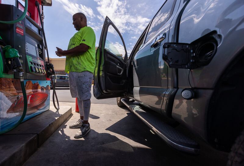 Jesse Griffin pays at a fuel pump before filling his truck at a Maverik gas station in Midvale, Utah.