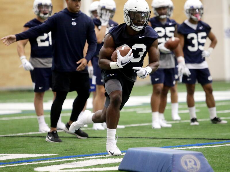 Emmanuel Esukpa runs a drill as BYU opens football practice at the indoor facility in Provo on Wednesday, July 31, 2019.