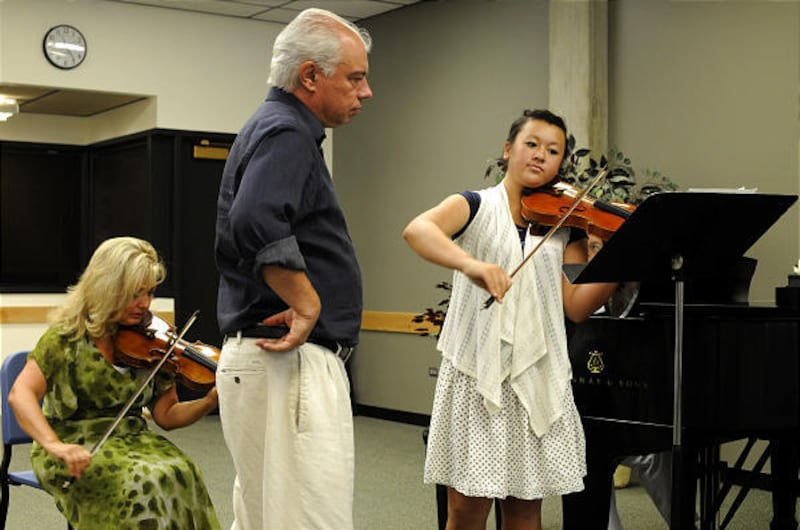 Igor (center) and Vesna (seated on left) Gruppman work with violin student Sabrina Parry at a masterclass.