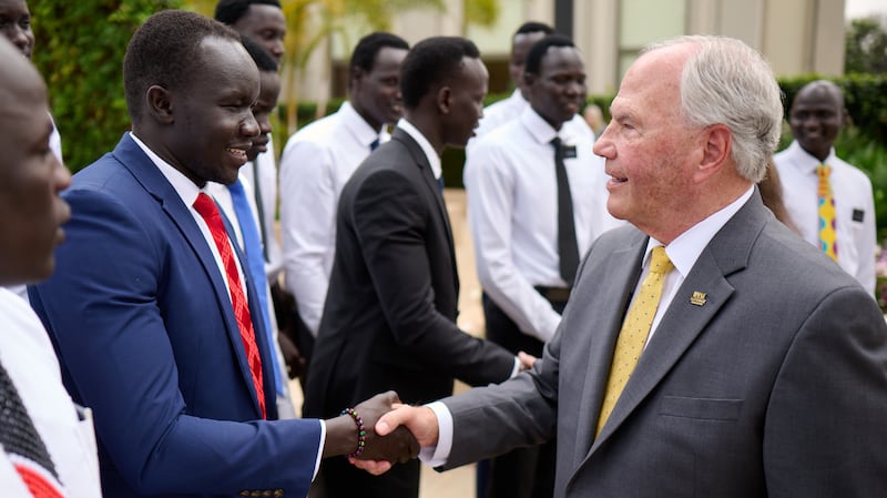 Elder Ronald A. Rasband greets young adults from South Sudan in Nairobi, Kenya, Oct. 25, 2025.