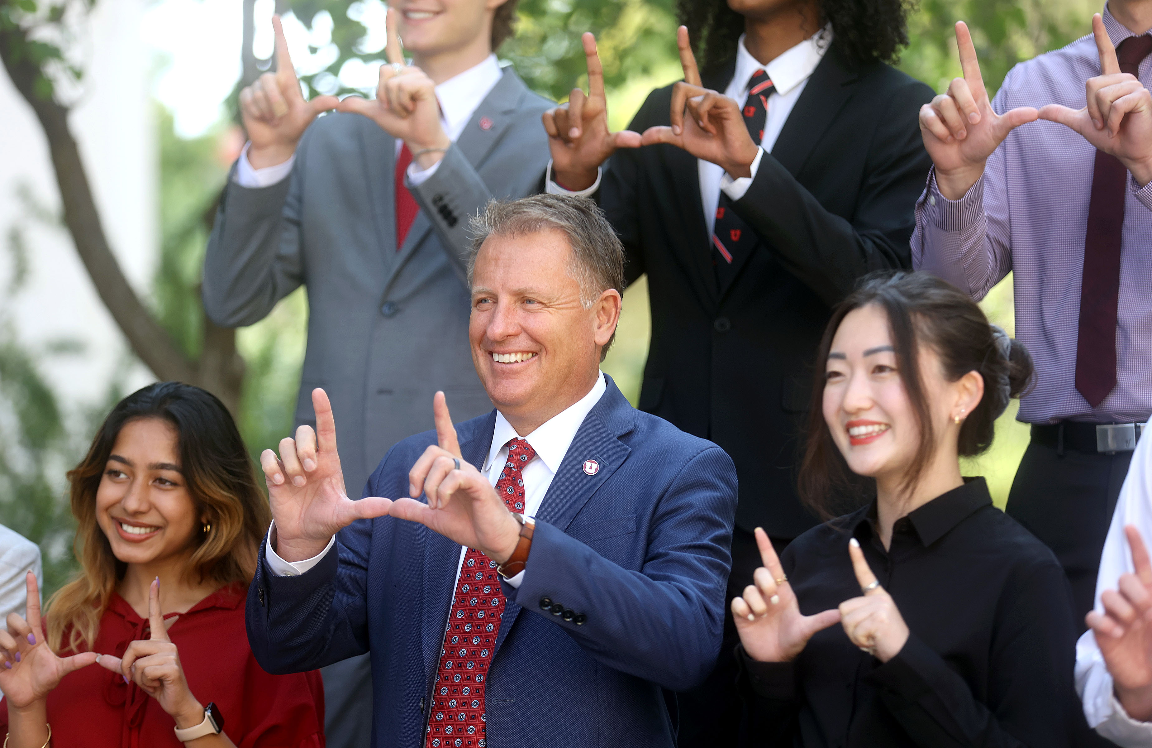 University of Utah President Taylor Randall, center, makes a “U” sign while posing for a photo with presidential interns at the University of Utah on Aug. 20, 2021.