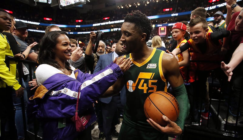 Utah Jazz guard Donovan Mitchell (45) greets his girlfriend Deja Lighty as the exits the floor after the Utah Jazz defeat the Milwaukee Bucks 115-111 at Vivint Smart Home Arena in Salt Lake City on Saturday, March 2, 2019.