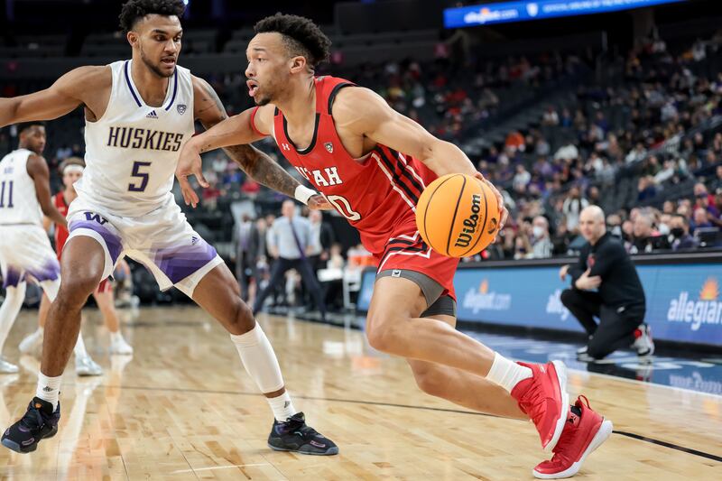 Utah Utes guard Marco Anthony drives against Washington Huskies’ Jamal Bey during a Pac-12 tournament game in Las Vegas on.